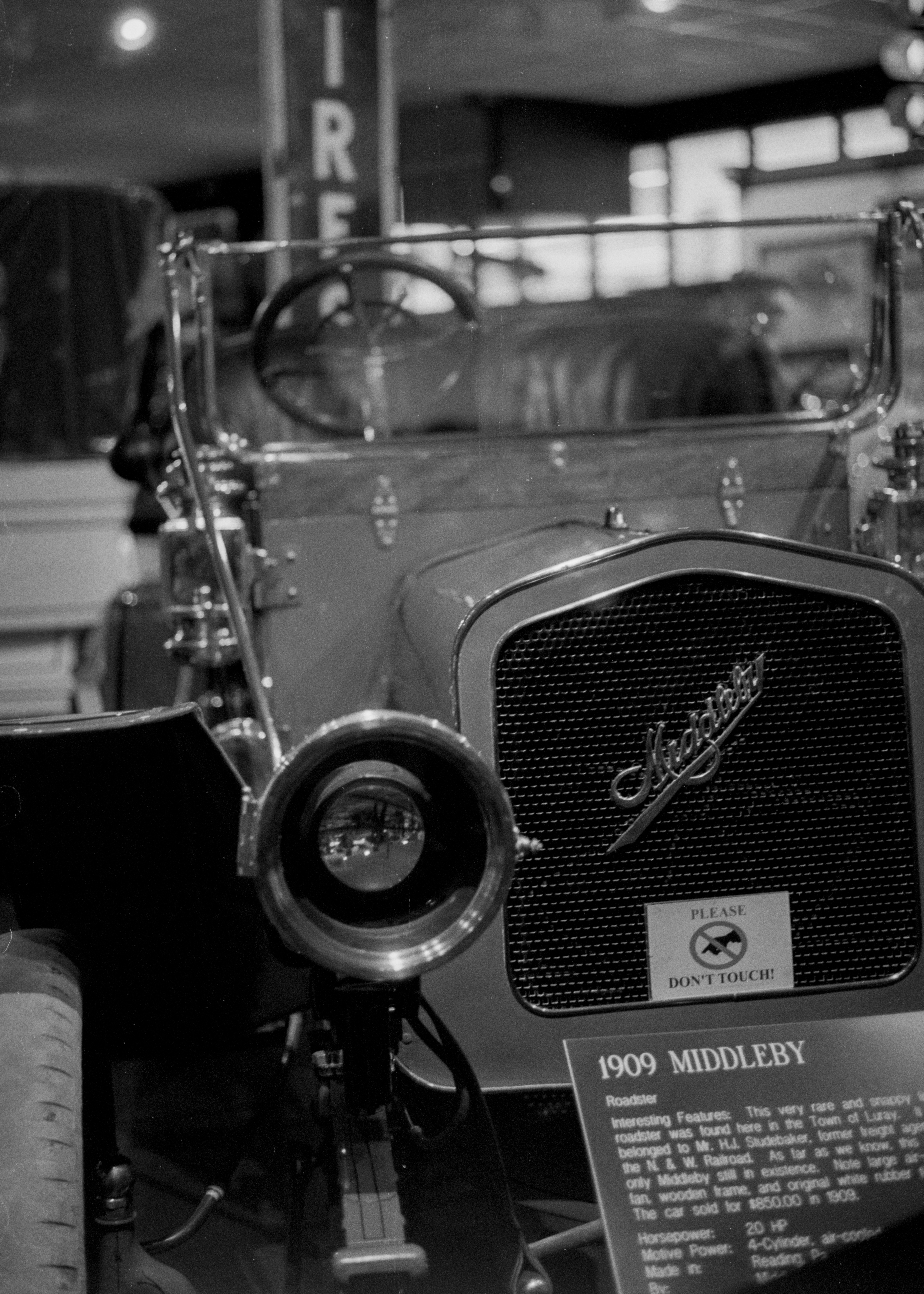 an old car is on display in a museum
