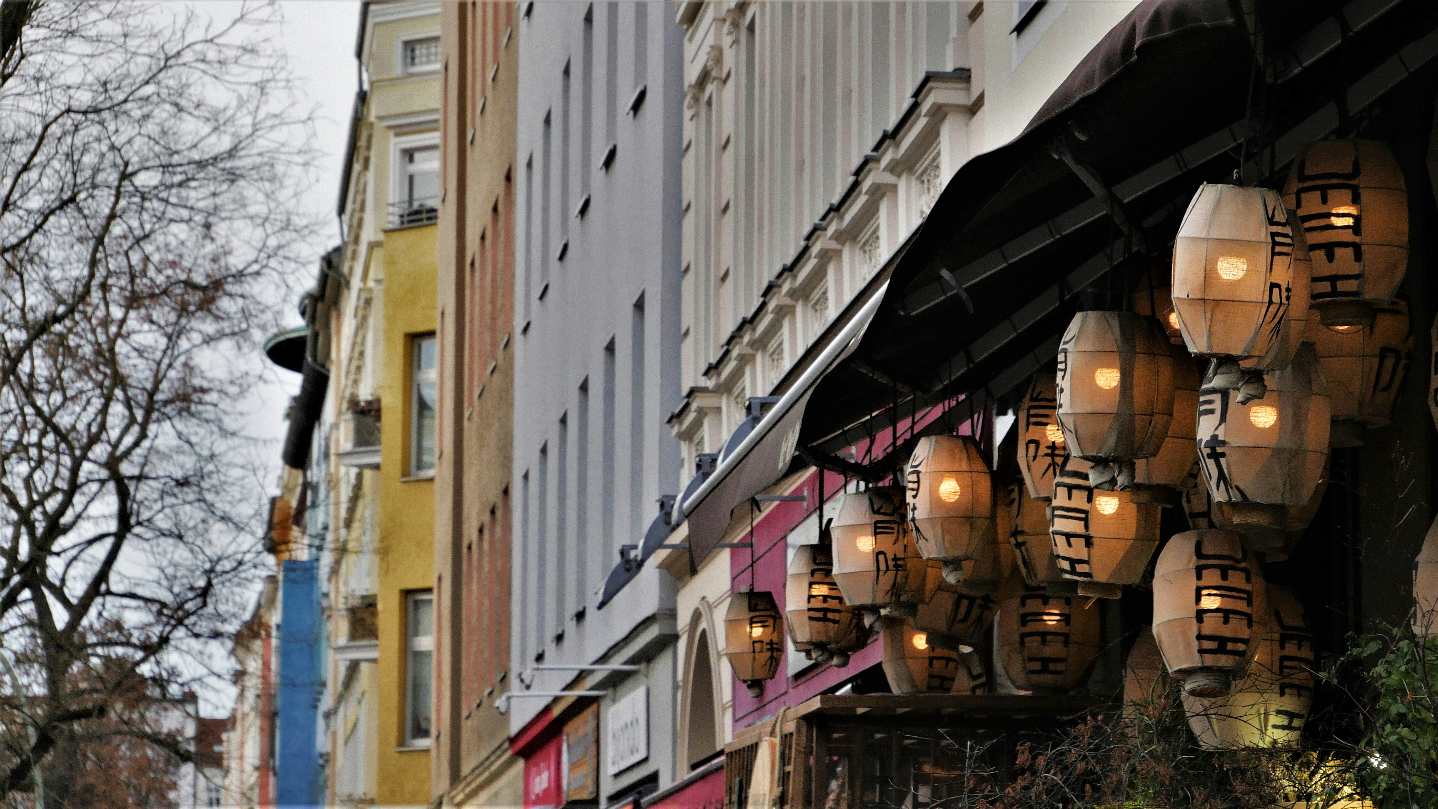 A bunch of lights hanging from the side of a building photo Free