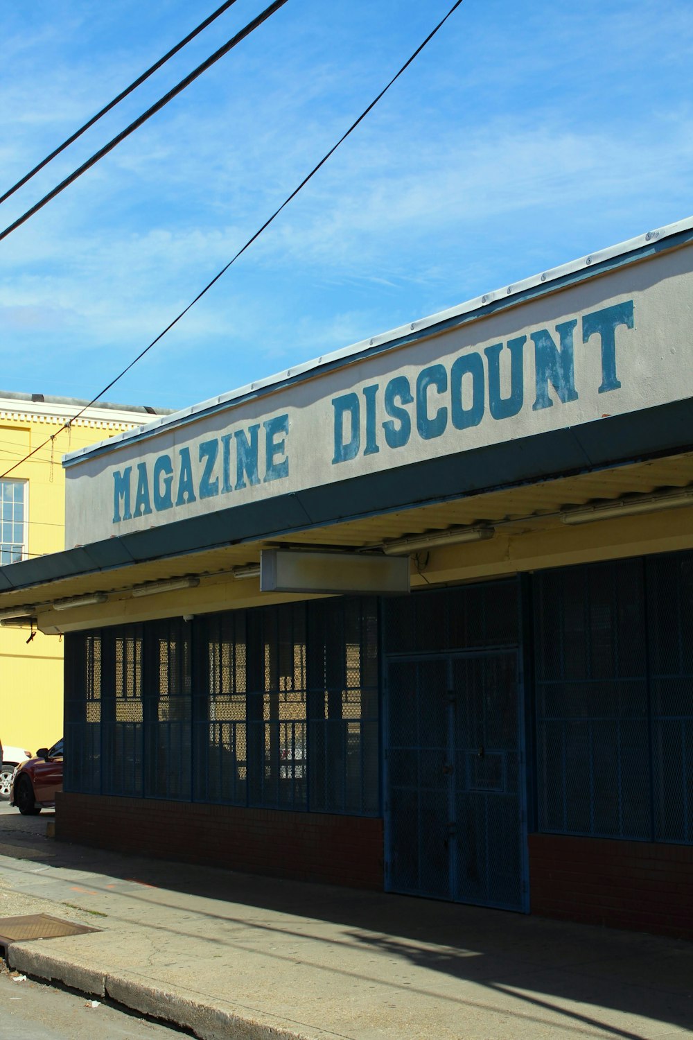 the front of a magazine discount store on a city street