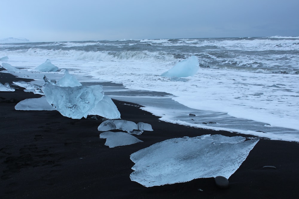 a group of icebergs sitting on top of a beach