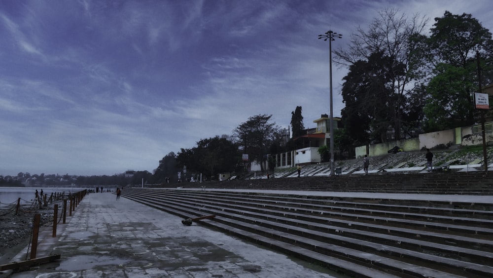 a row of seats sitting next to a body of water