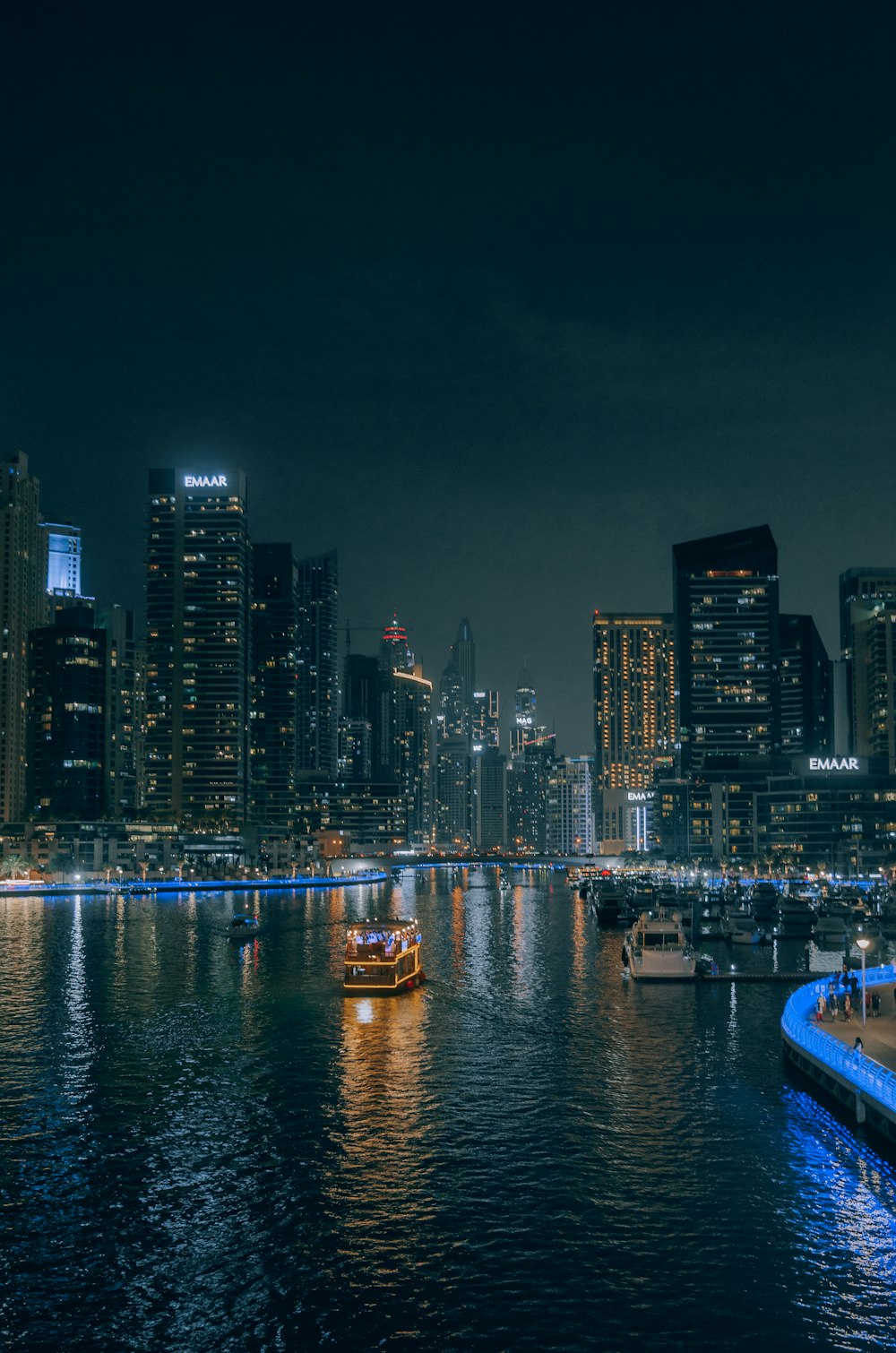 a small boat in a body of water with a city in the background