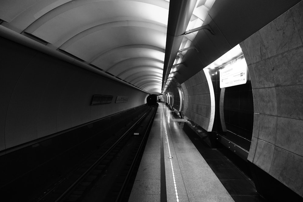 a black and white photo of a subway tunnel