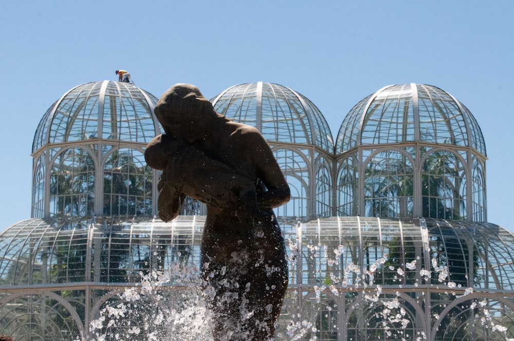 a statue of a bear in front of a fountain