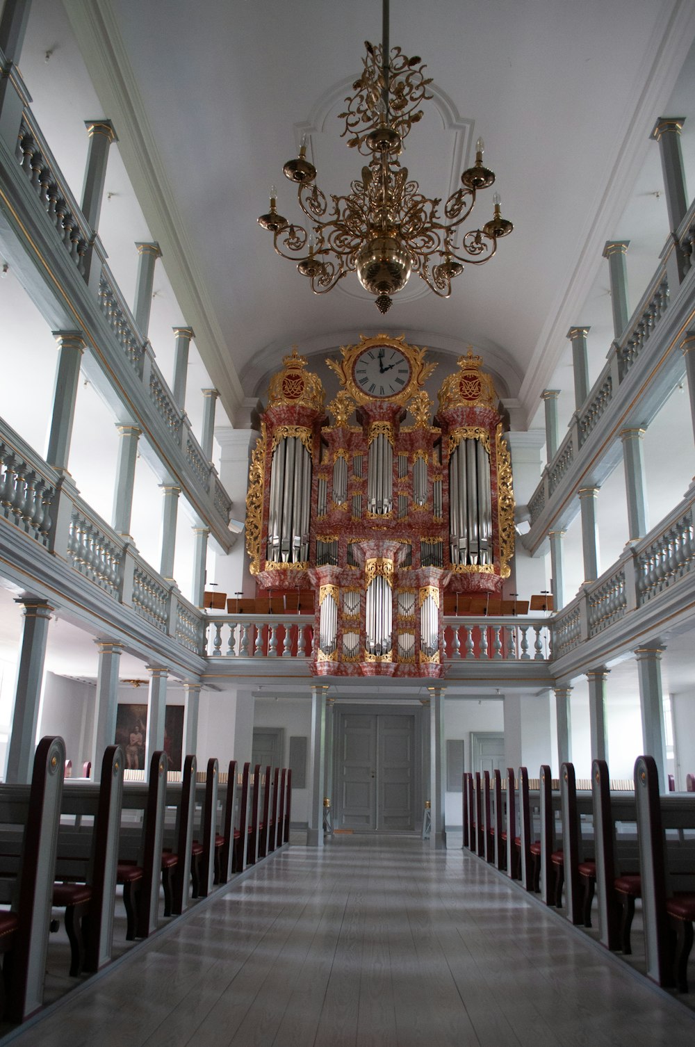 a large room with a chandelier and a pipe organ