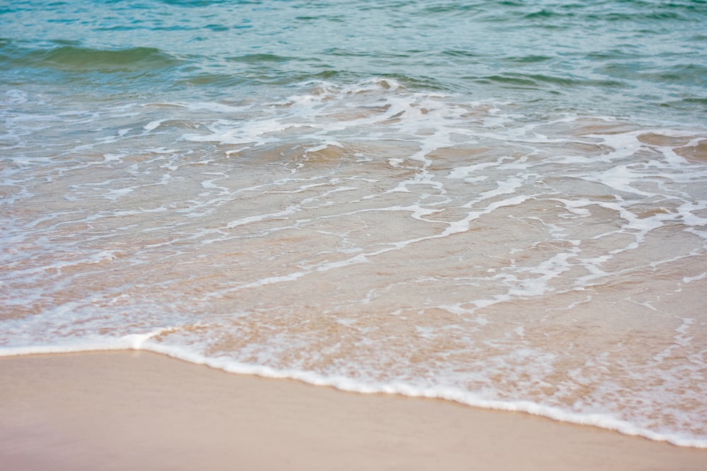 a close up of a wave on a beach