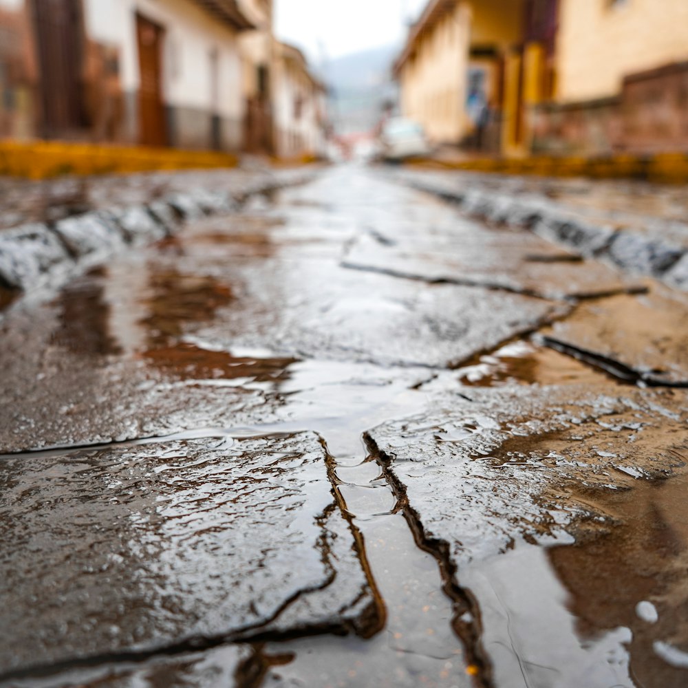 a wet street with a stop sign on it