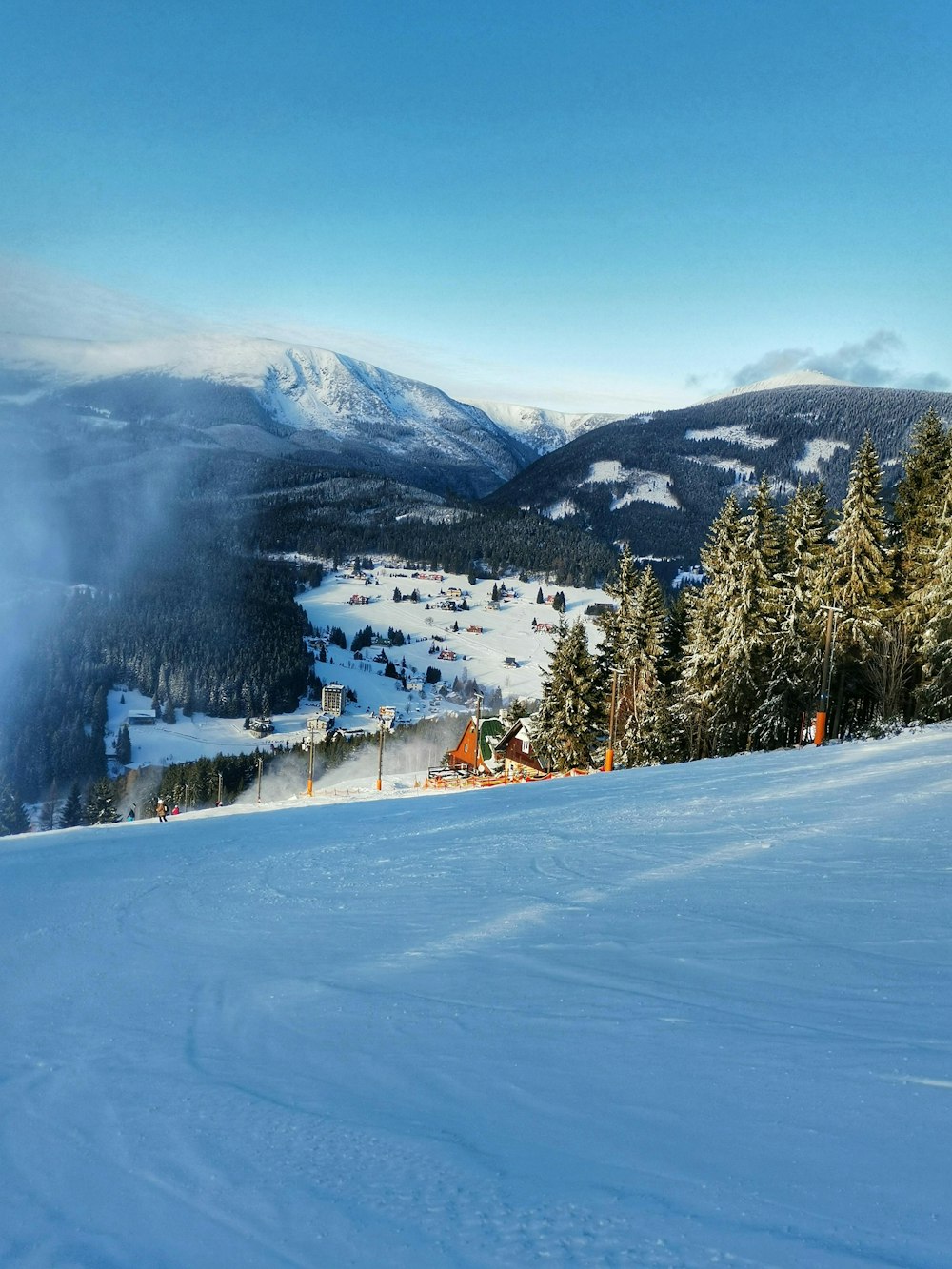 a person riding skis on top of a snow covered slope