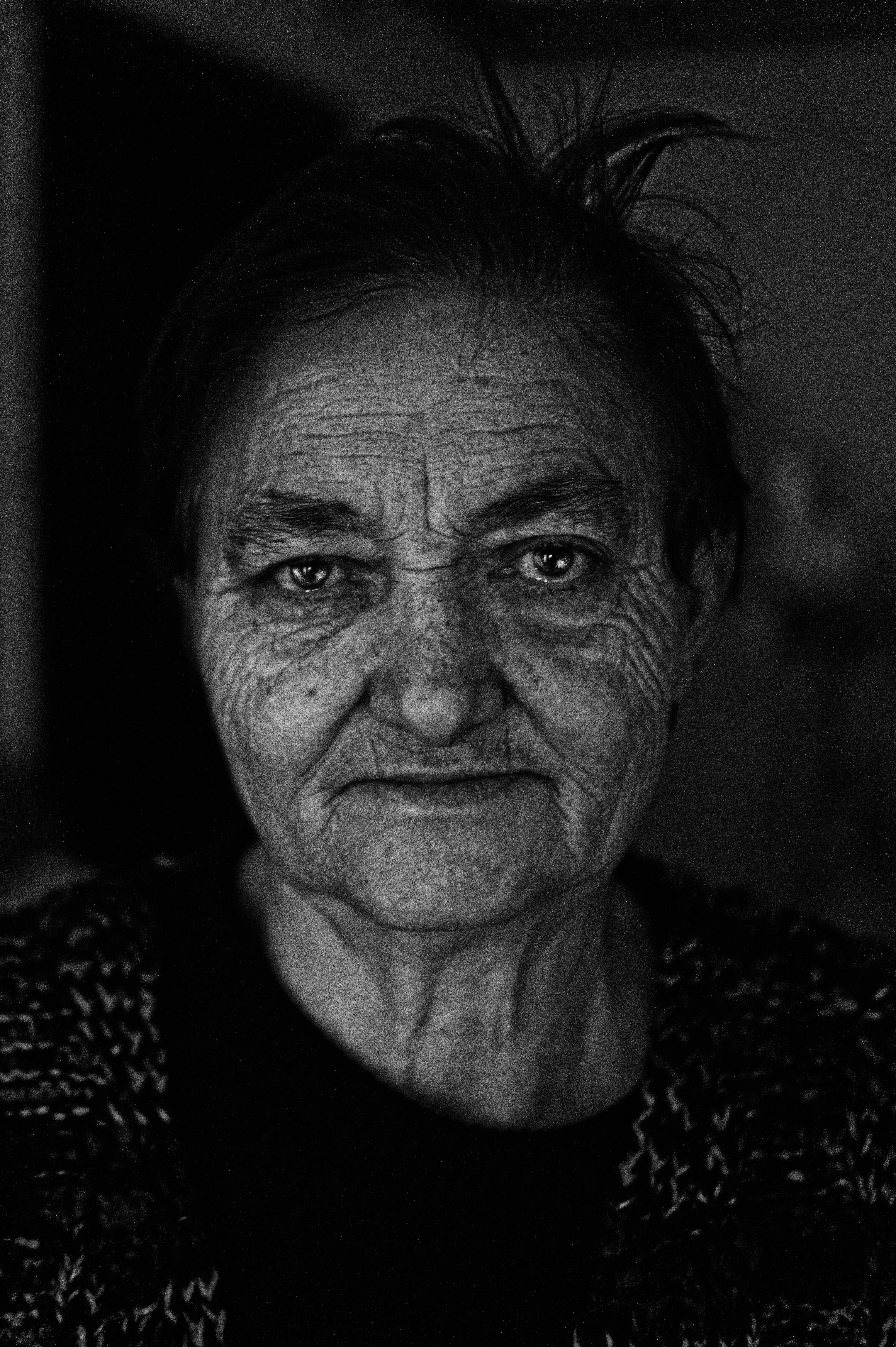 a black and white photo of an old woman