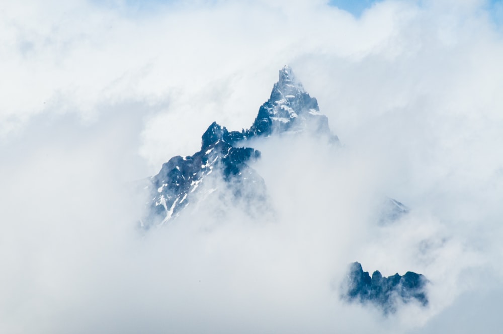 a very tall mountain covered in lots of clouds