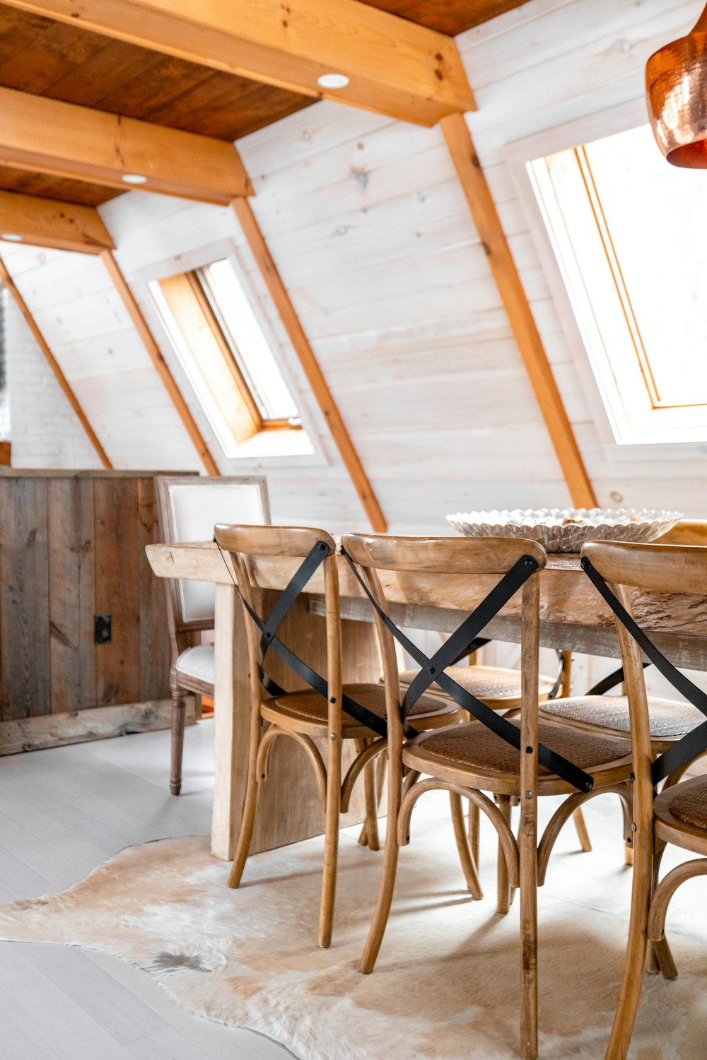 a dining room table in front of a wooden chair