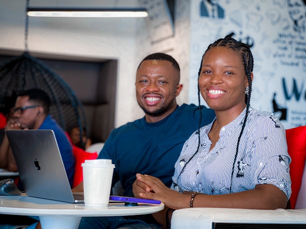 Portrait of Marcelo and Tania Freitas smiling confidently in an office setting.