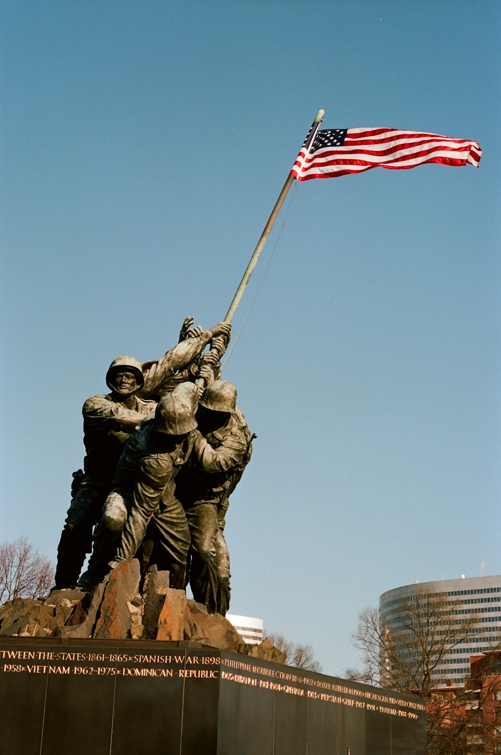 a statue with a flag on top of it