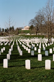 a field full of headstones in front of a building