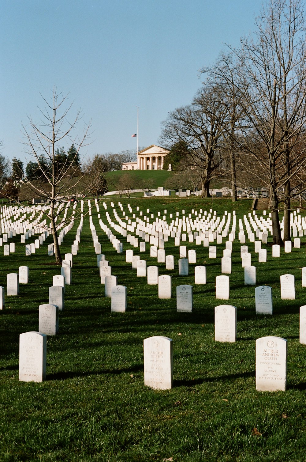 a field full of headstones in front of a building