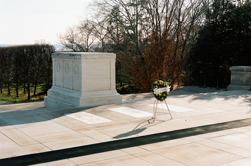 a memorial in a park with a tree in the background