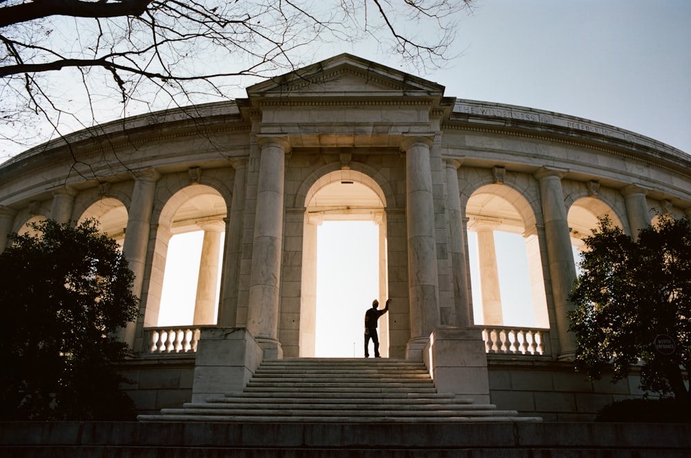 a person standing on a set of steps in front of a building