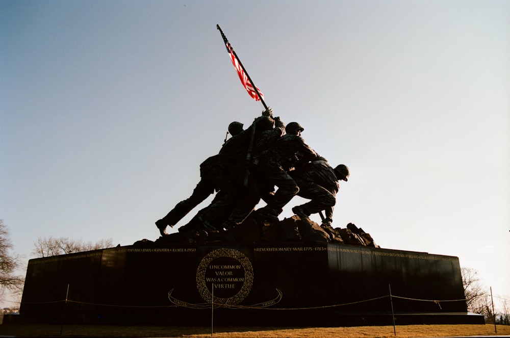 a group of soldiers standing on top of a monument
