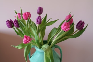 A charming arrangement of pastel tulips in a vintage ceramic vase