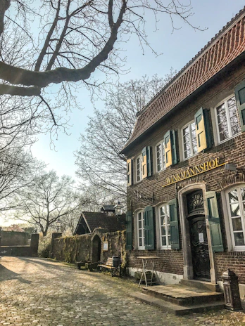 Photo of the Suttner GmbH office building at Alkenbrede 1, Lemgo, bathed in morning light.