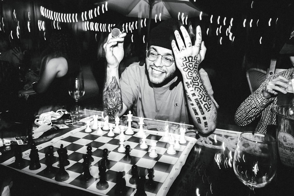 a black and white photo of a man playing chess