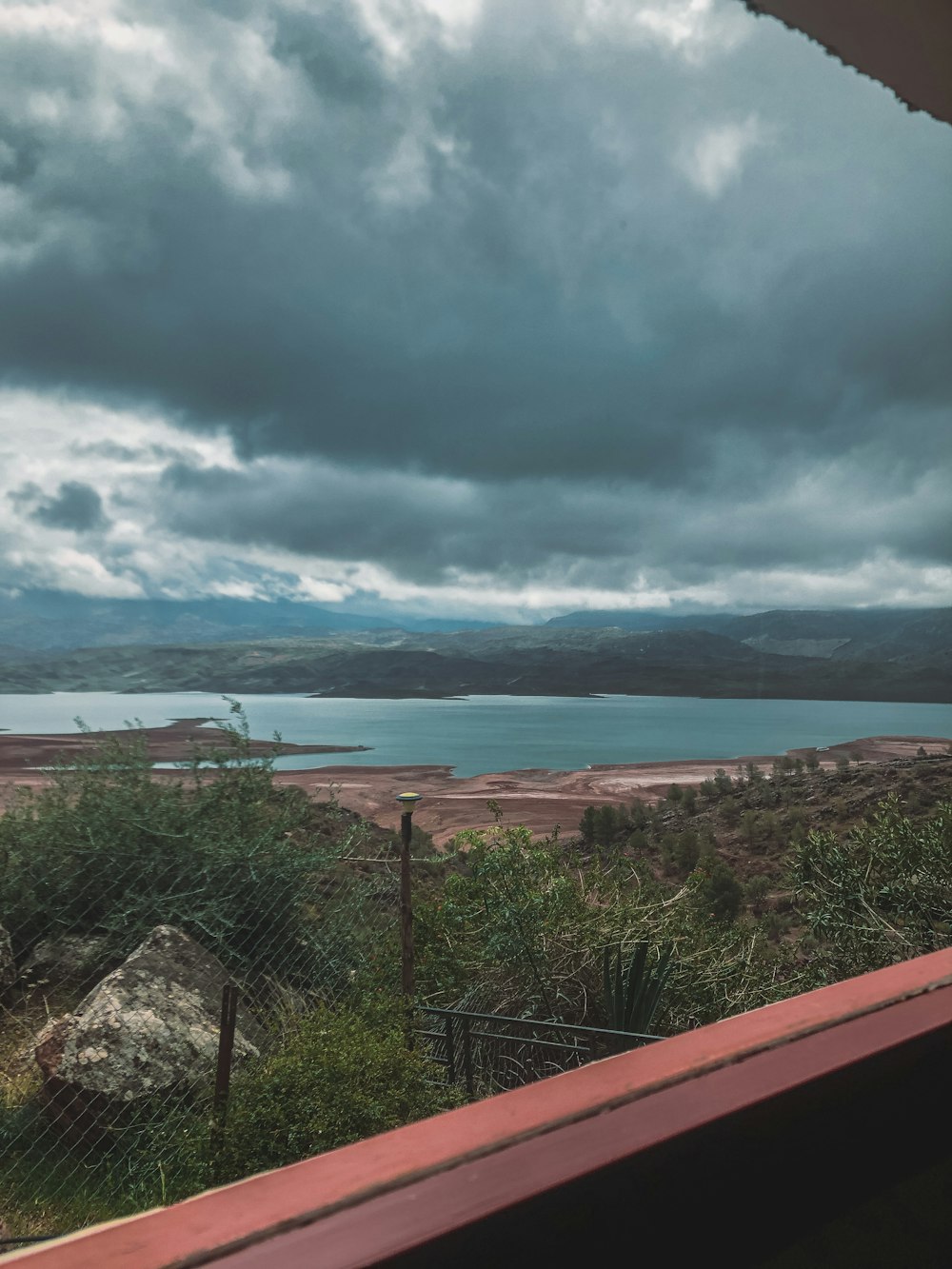 a large body of water sitting under a cloudy sky