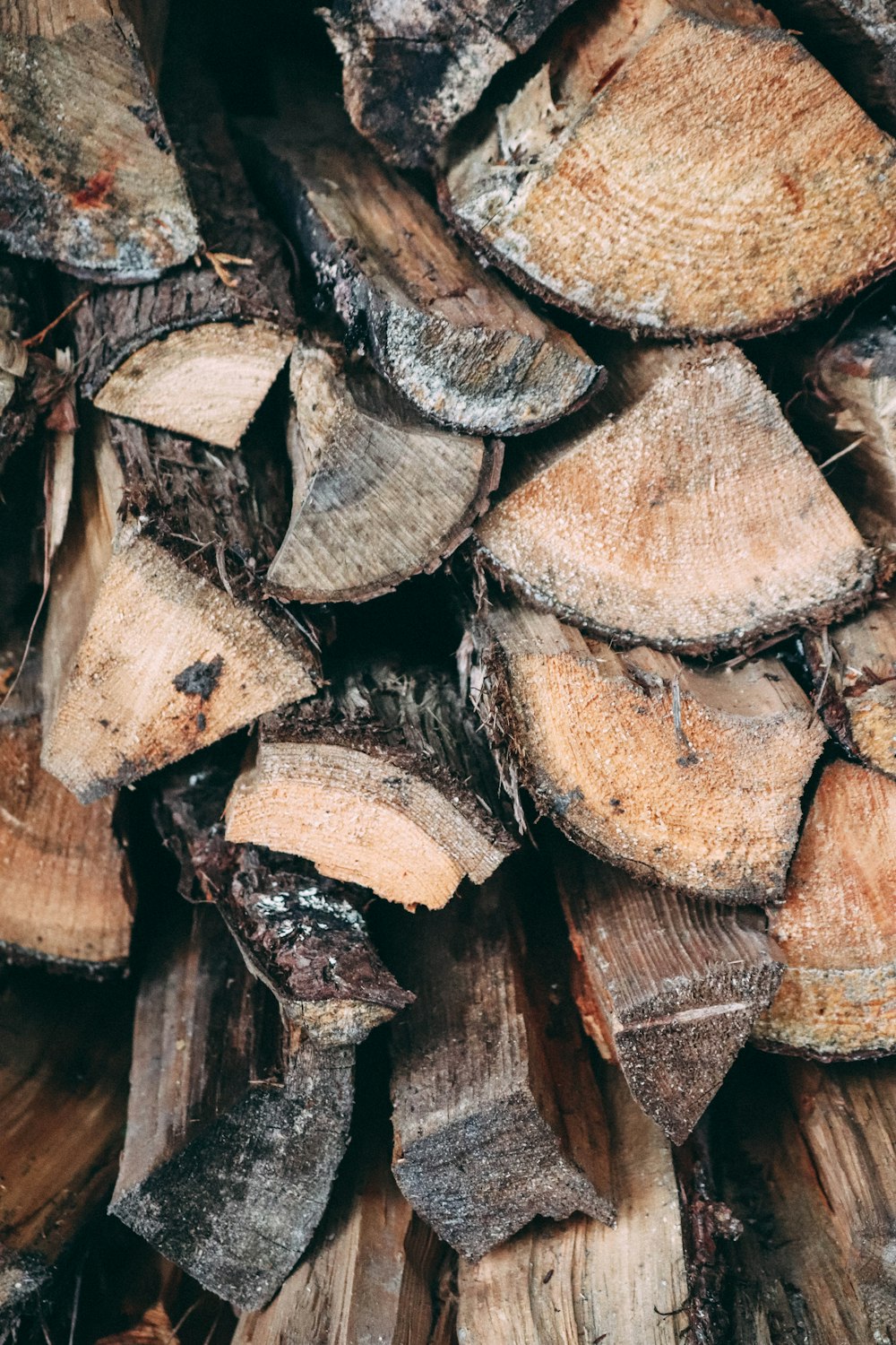 a pile of chopped wood sitting on top of a wooden floor