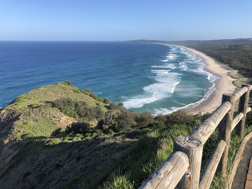 a view of a beach from a hill overlooking the ocean