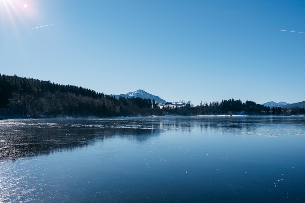 a body of water with a mountain in the background