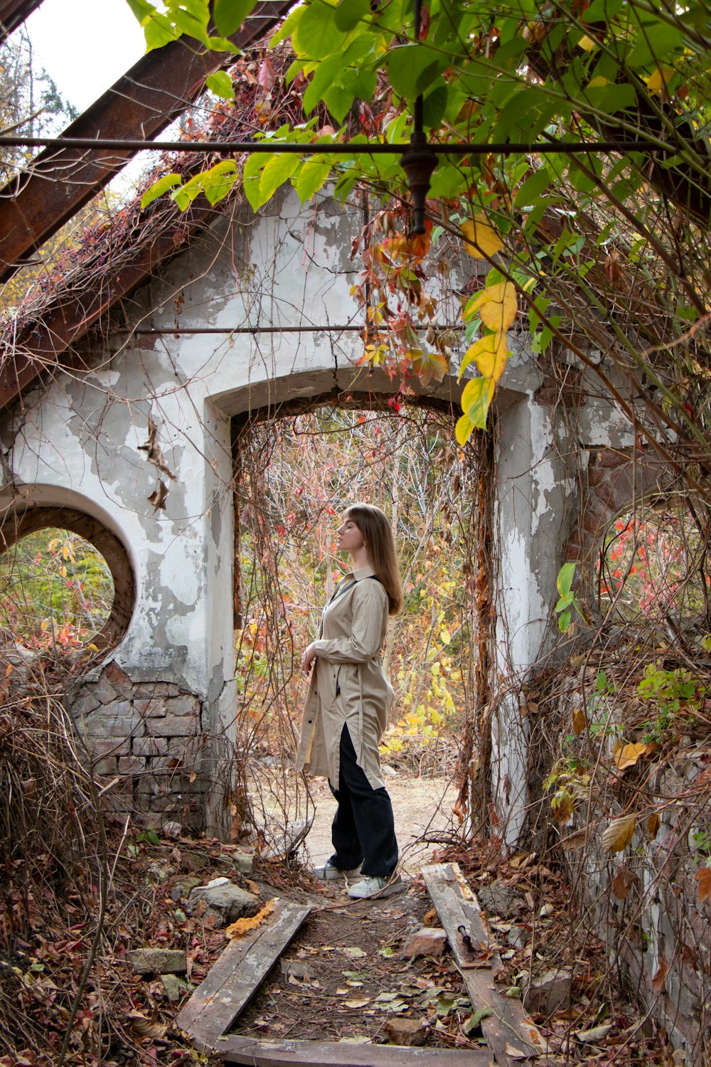 a woman standing in a doorway of an old building