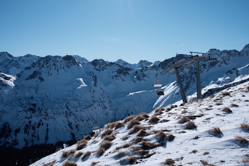 a ski lift on the side of a snow covered mountain