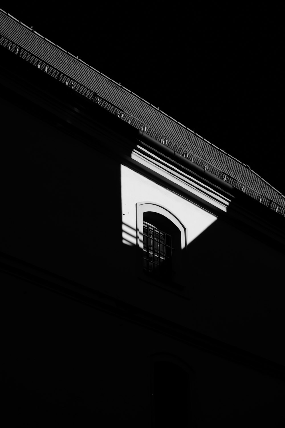a black and white photo of a building with a window