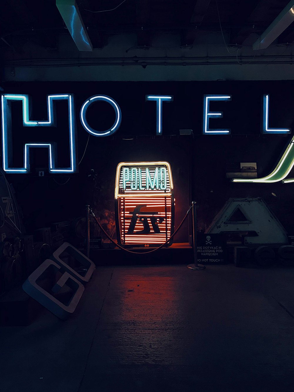 a neon sign that reads hotel palo in front of a building