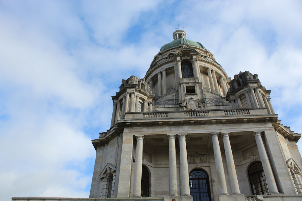 a very tall building with columns and a clock