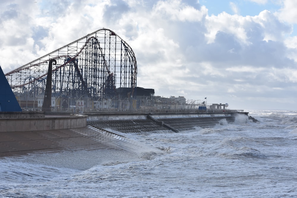 a roller coaster in the middle of a body of water