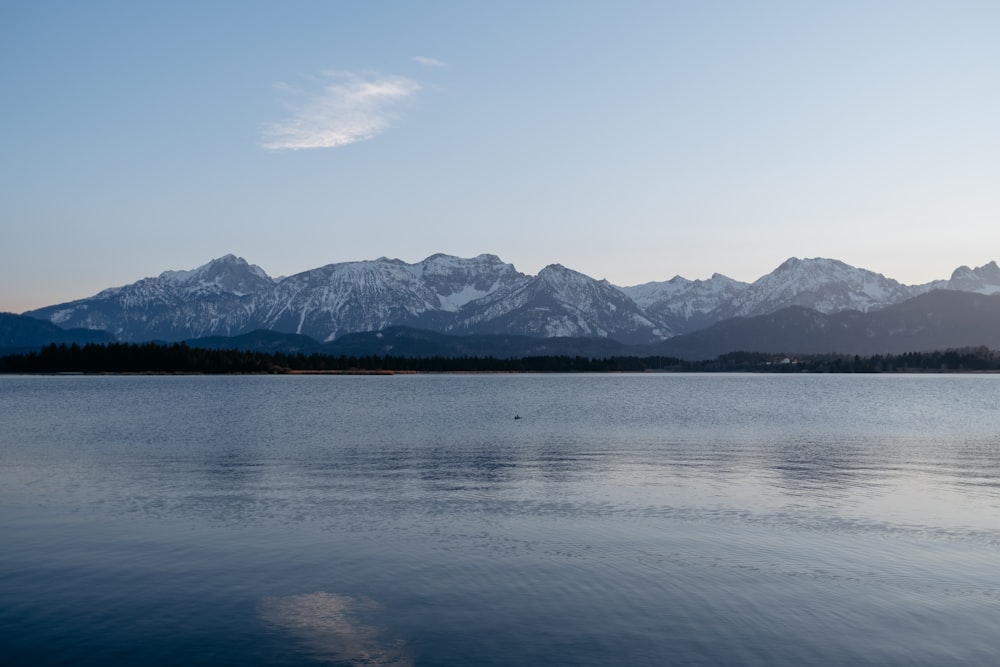 a large body of water with mountains in the background