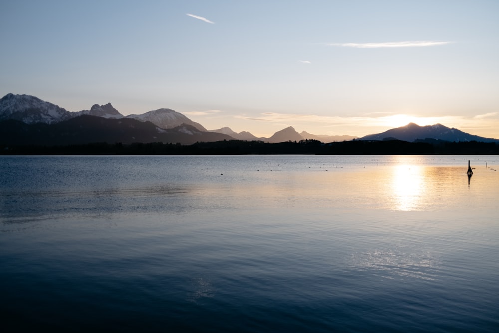 a body of water with mountains in the background