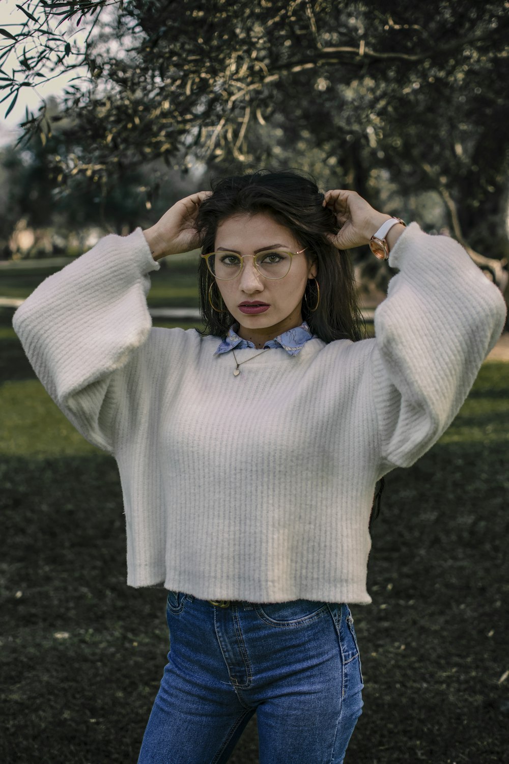 a woman in a white sweater and bow tie