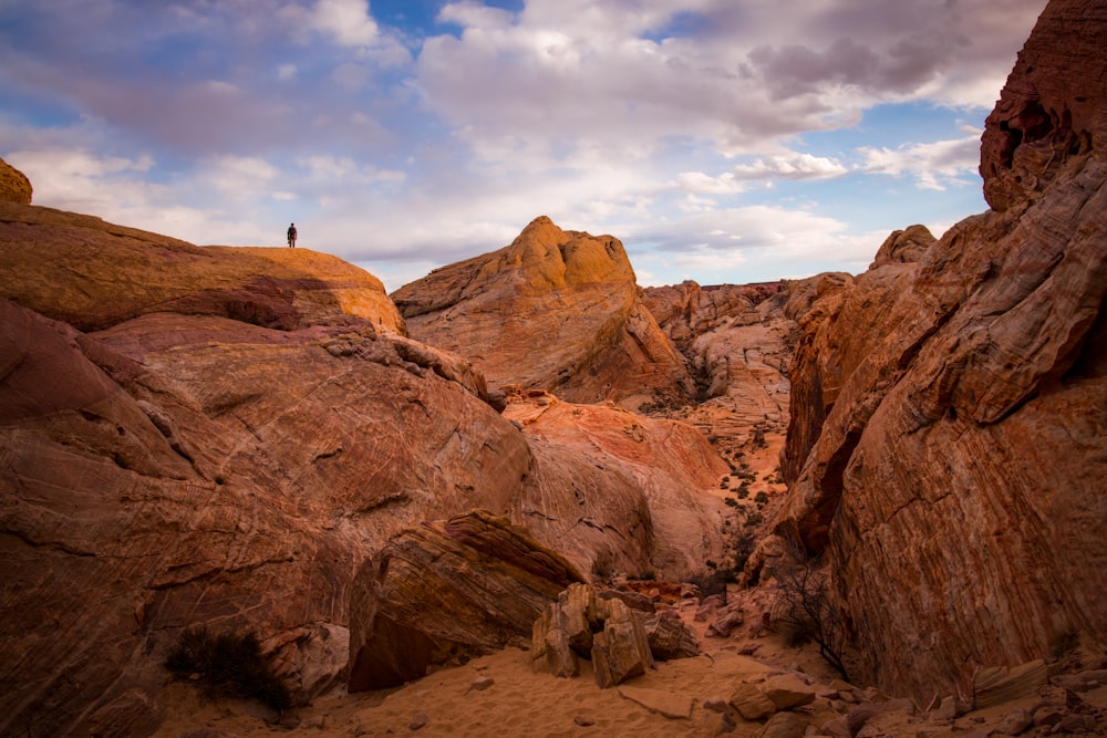 a person standing on top of a large rock formation