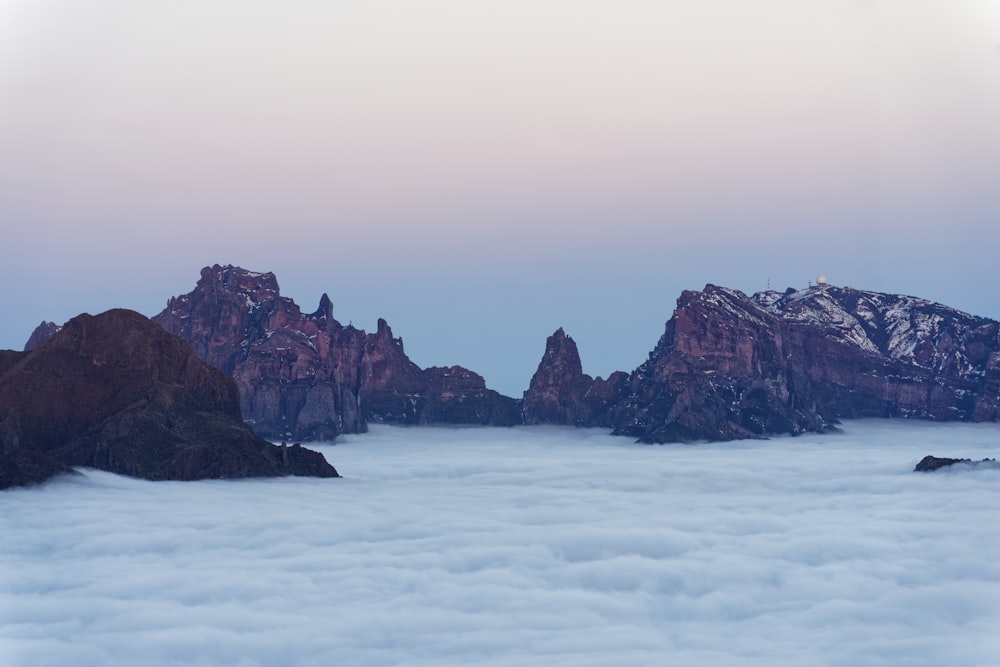 a view of a mountain range above the clouds