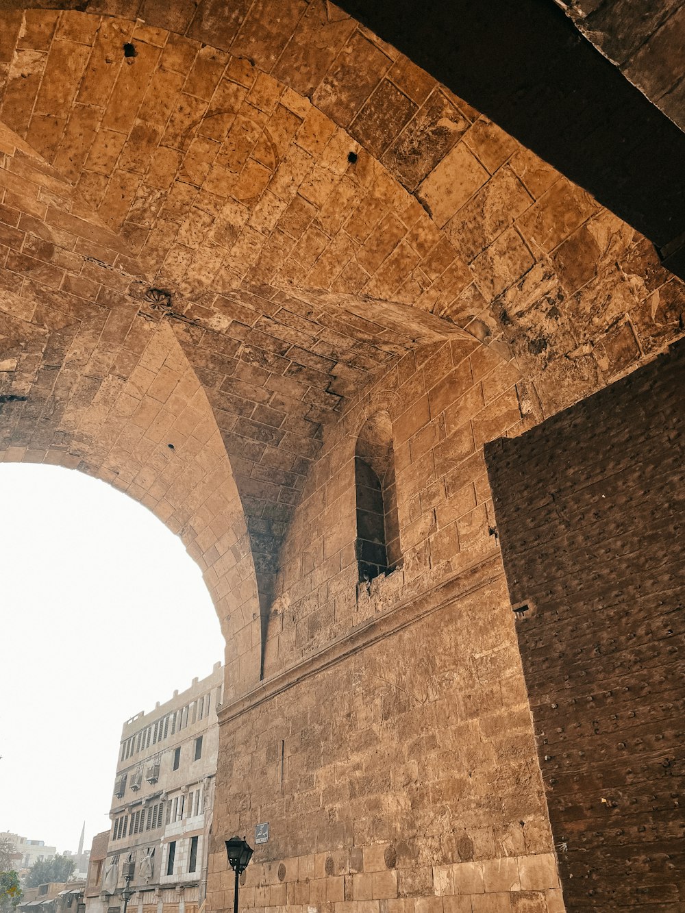 a large stone bridge over a city street