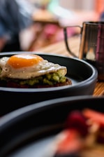 a plate of food with an egg on top of it
