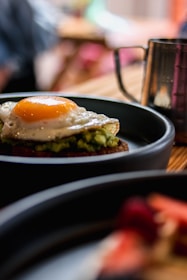 a plate of food with an egg on top of it
