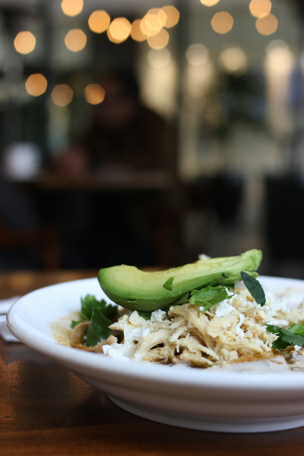 a plate of food with a cucumber on top of it