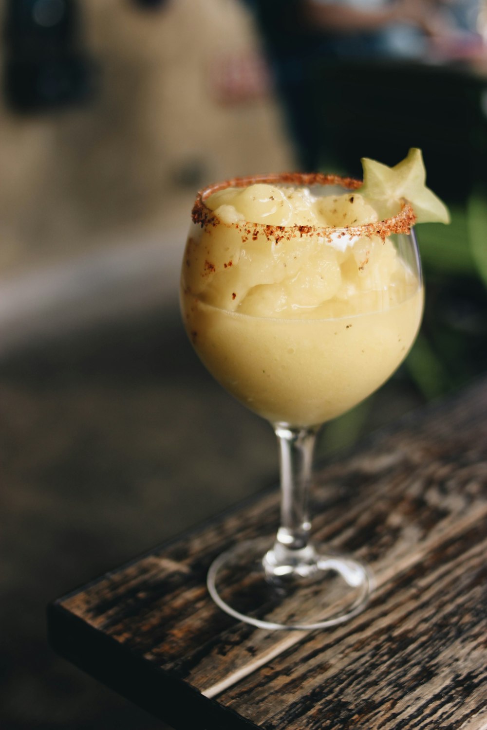 a drink sitting on top of a wooden table