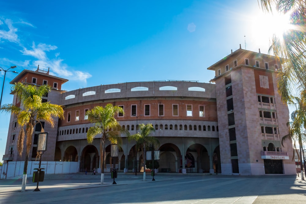 a large building with palm trees in front of it