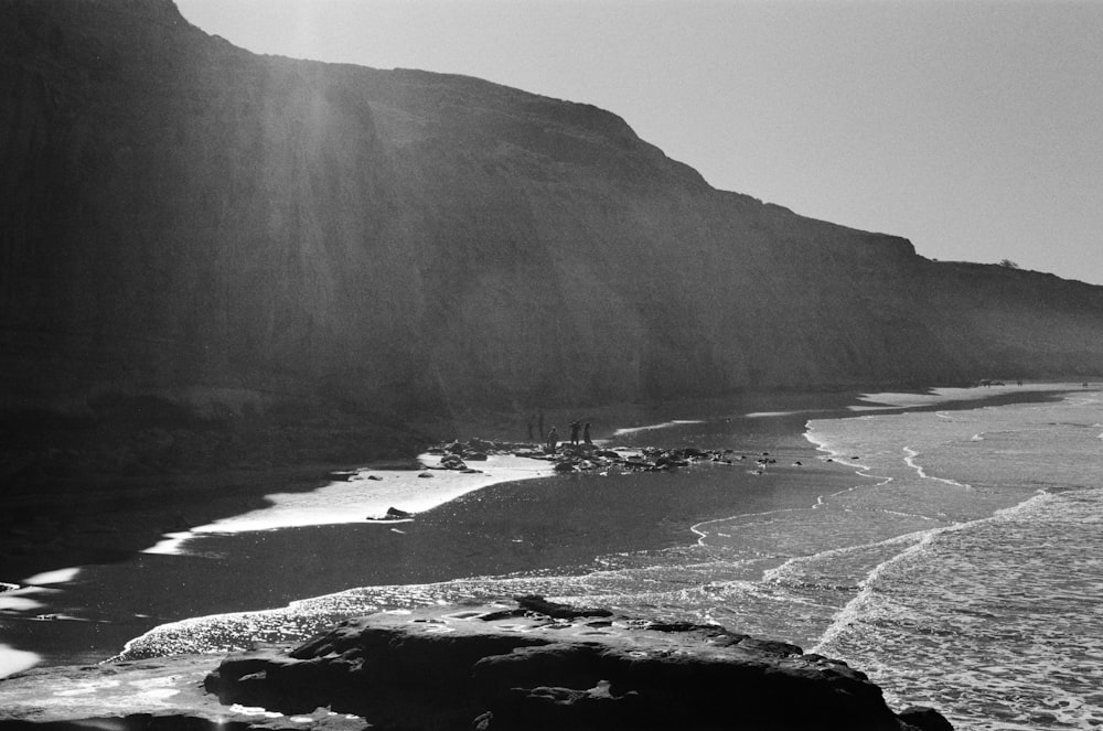 a black and white photo of a rocky beach