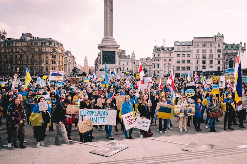 a large group of people holding signs and flags