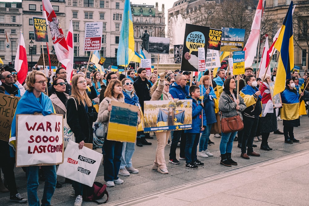 a large group of people holding signs and flags