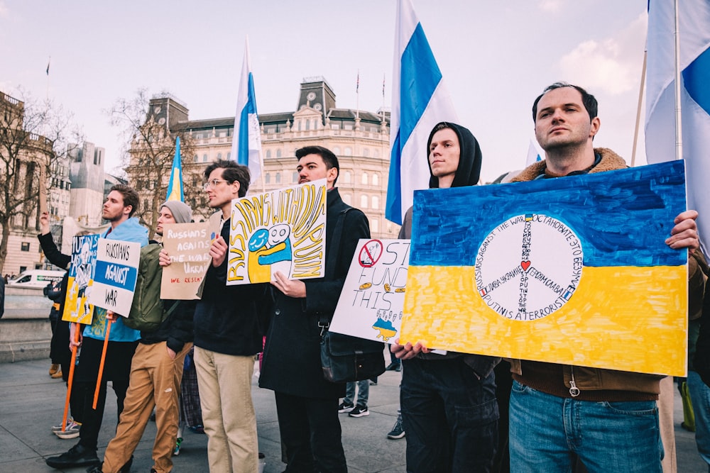 a group of people holding signs and flags